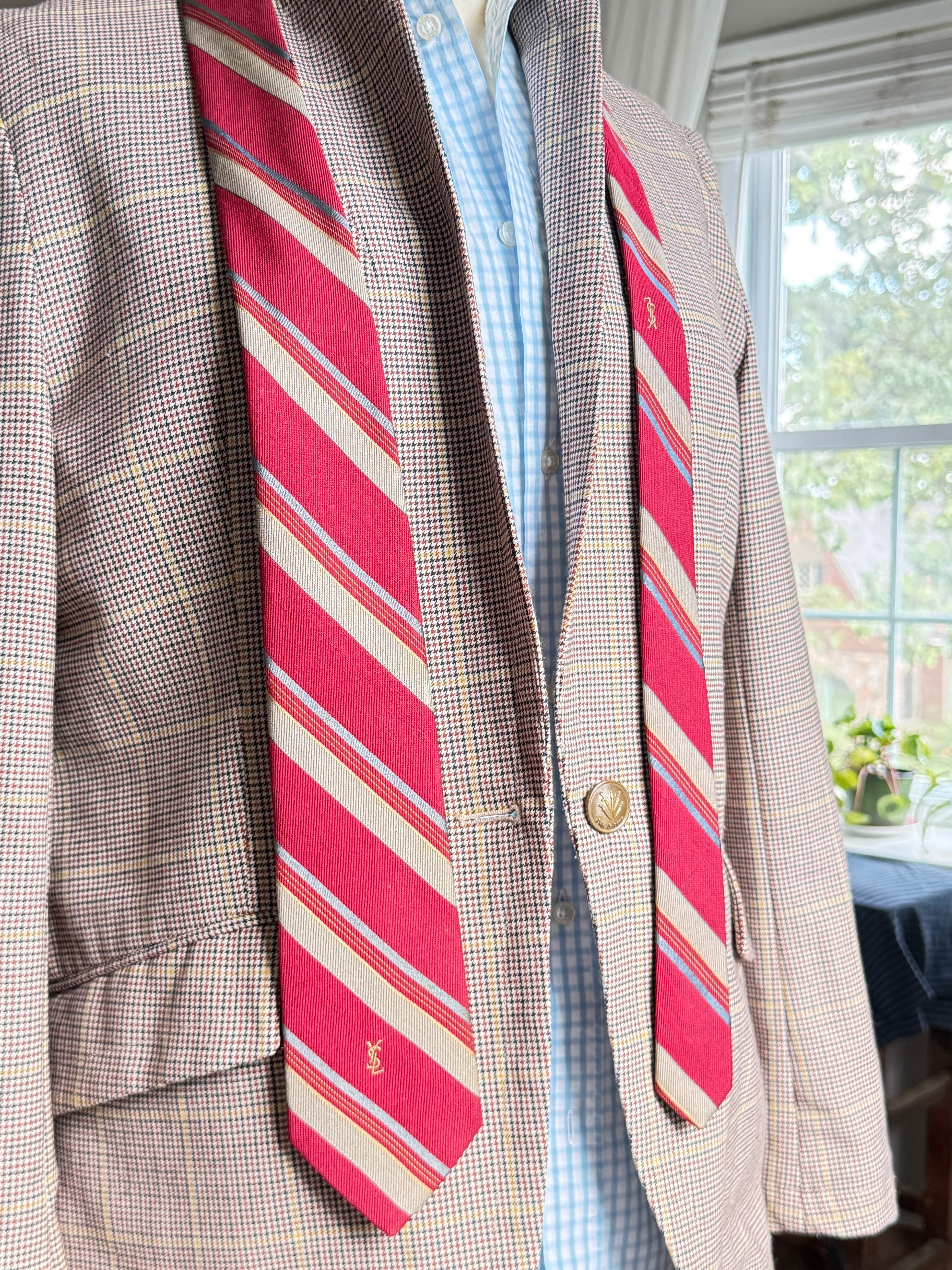 Vintage Yves Saint Laurent crimson repp-stripe tie with sand and sky-blue diagonal stripes, styled over a blue gingham shirt and houndstooth jacket.