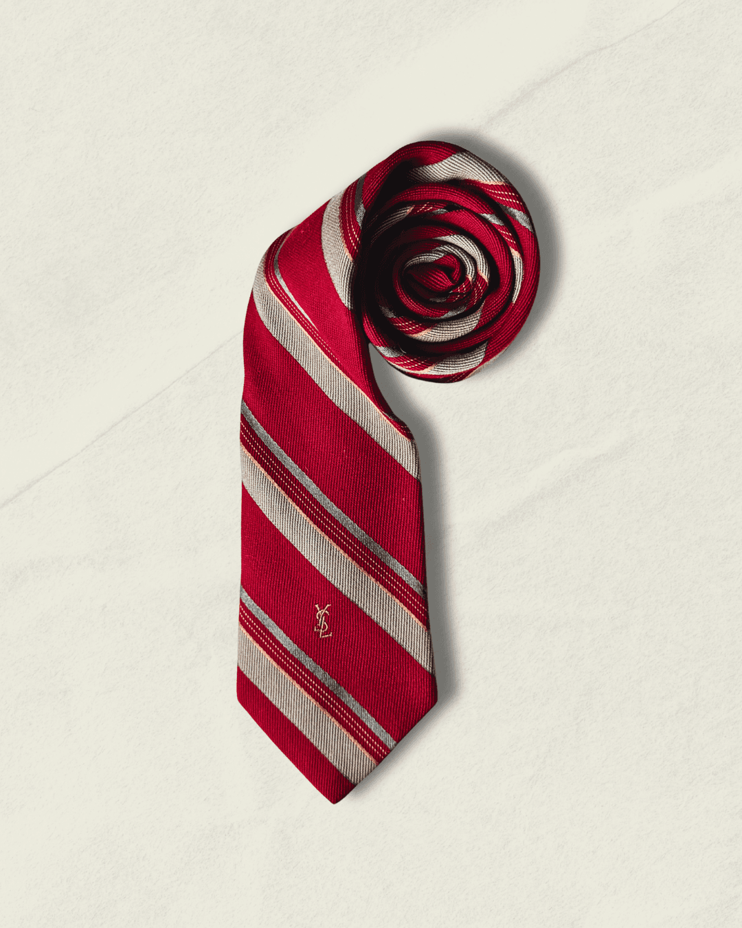 Vintage Yves Saint Laurent repp-stripe tie in crimson, sand, and sky blue. Regimental cut, embroidered YSL monogram