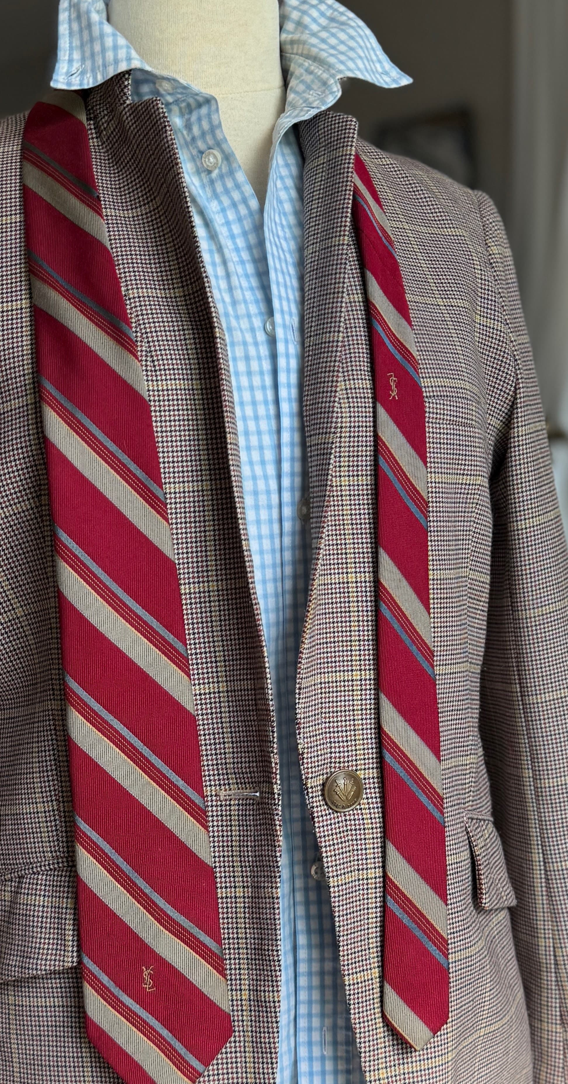 Vintage Yves Saint Laurent crimson repp-stripe tie with sand and sky-blue diagonal stripes, styled over a blue gingham shirt and houndstooth jacket.