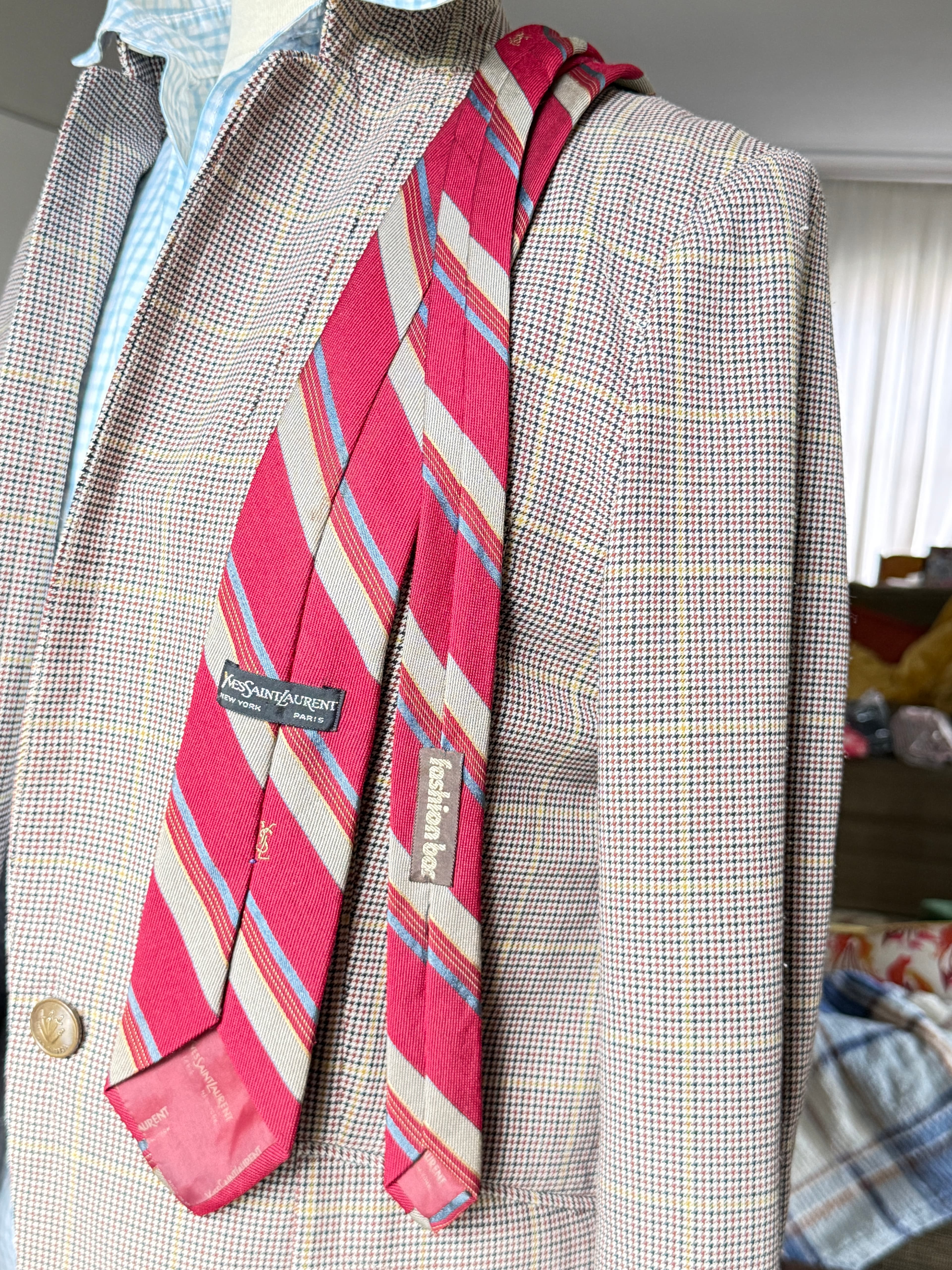 Vintage Yves Saint Laurent crimson repp-stripe tie with sand and sky-blue diagonal stripes, styled over a blue gingham shirt and houndstooth jacket.