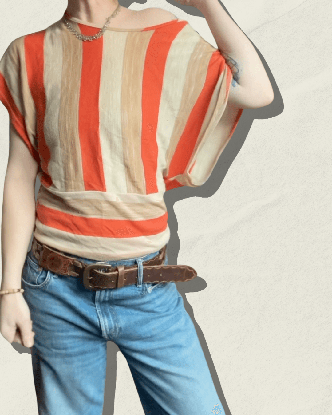 Vintage 70s Vamp striped knit top in coral, camel, and cream with dolman sleeves, shown flat.