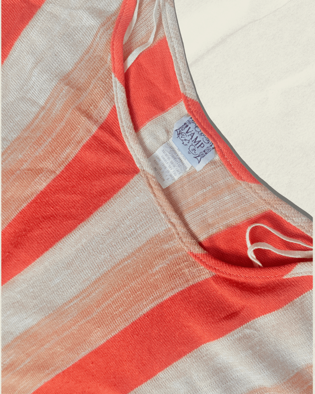 Vintage 70s Vamp striped knit top in coral, camel, and cream with dolman sleeves, shown flat.