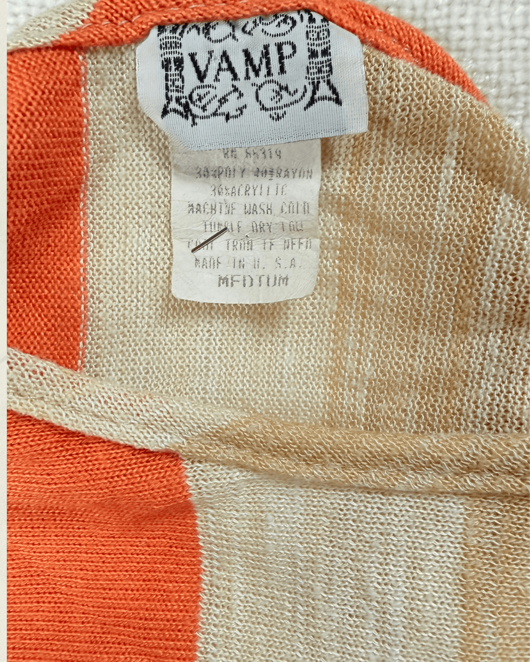 Vintage 70s Vamp striped knit top in coral, camel, and cream with dolman sleeves, shown flat.