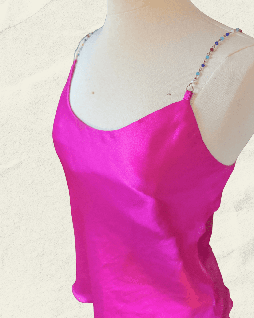 Y2K fuchsia Nicole Miller bias-cut silk camisole with multicolor hand-beaded straps and a draped neckline, shown flat.