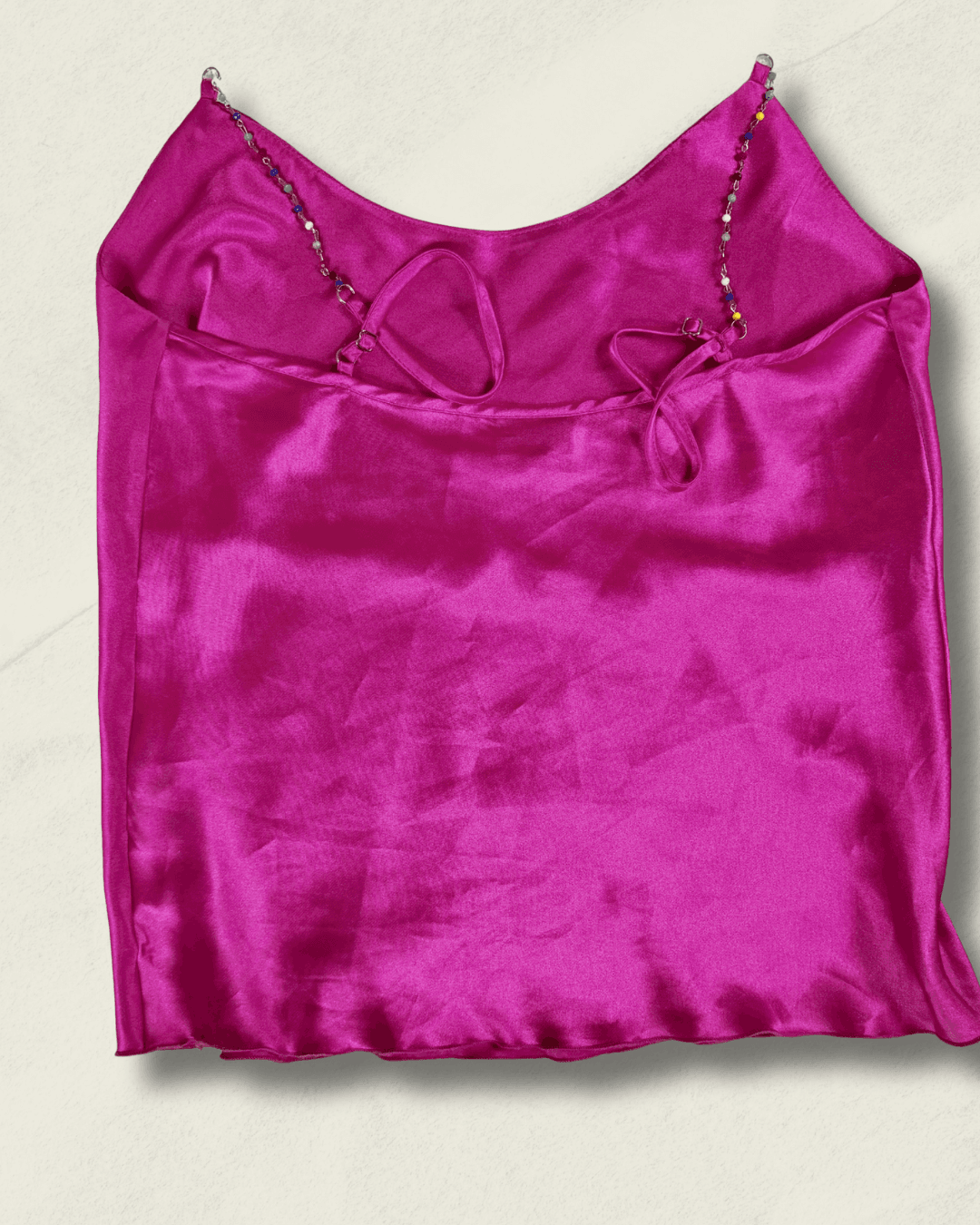 Y2K fuchsia Nicole Miller bias-cut silk camisole with multicolor hand-beaded straps and a draped neckline, shown flat.