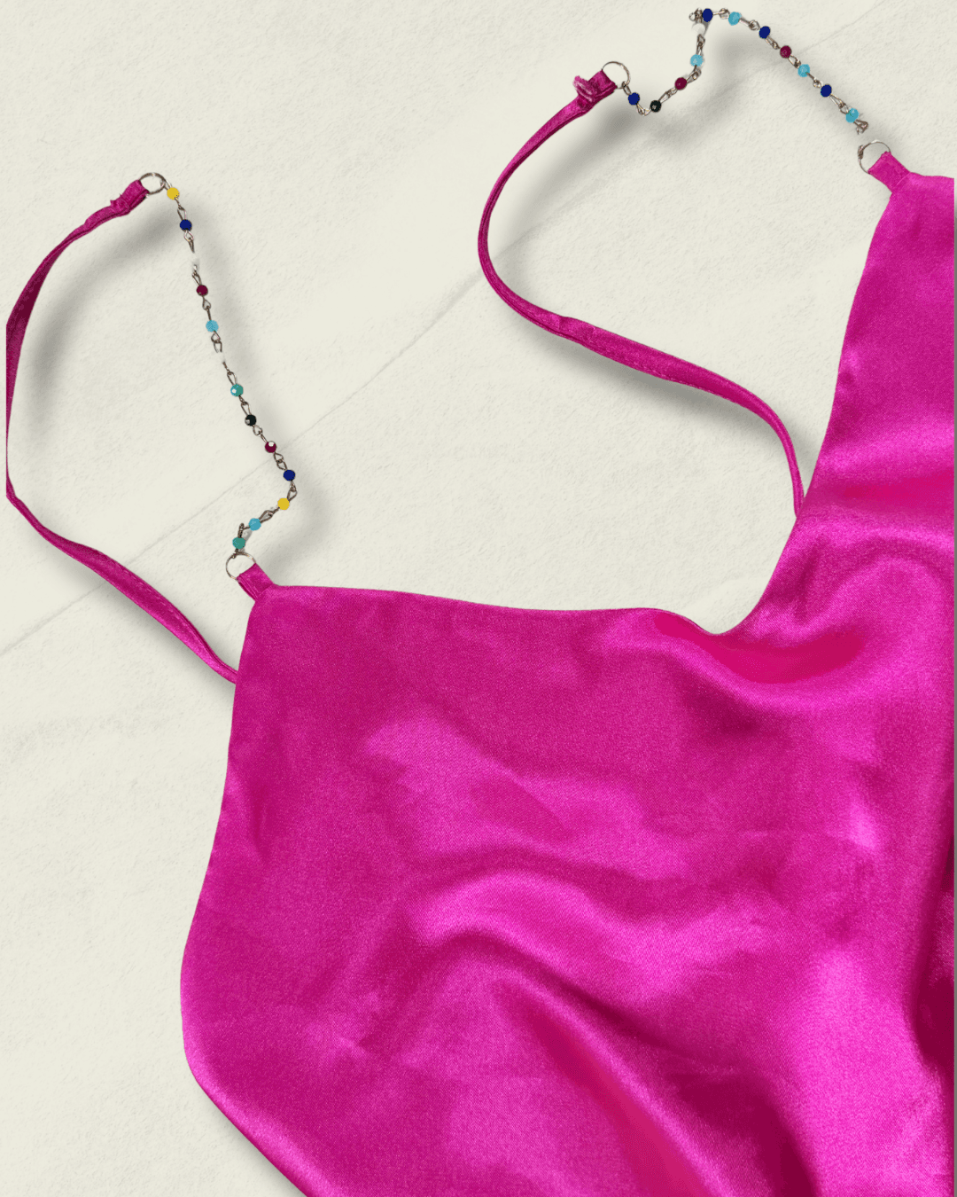 Y2K fuchsia Nicole Miller bias-cut silk camisole with multicolor hand-beaded straps and a draped neckline, shown flat.