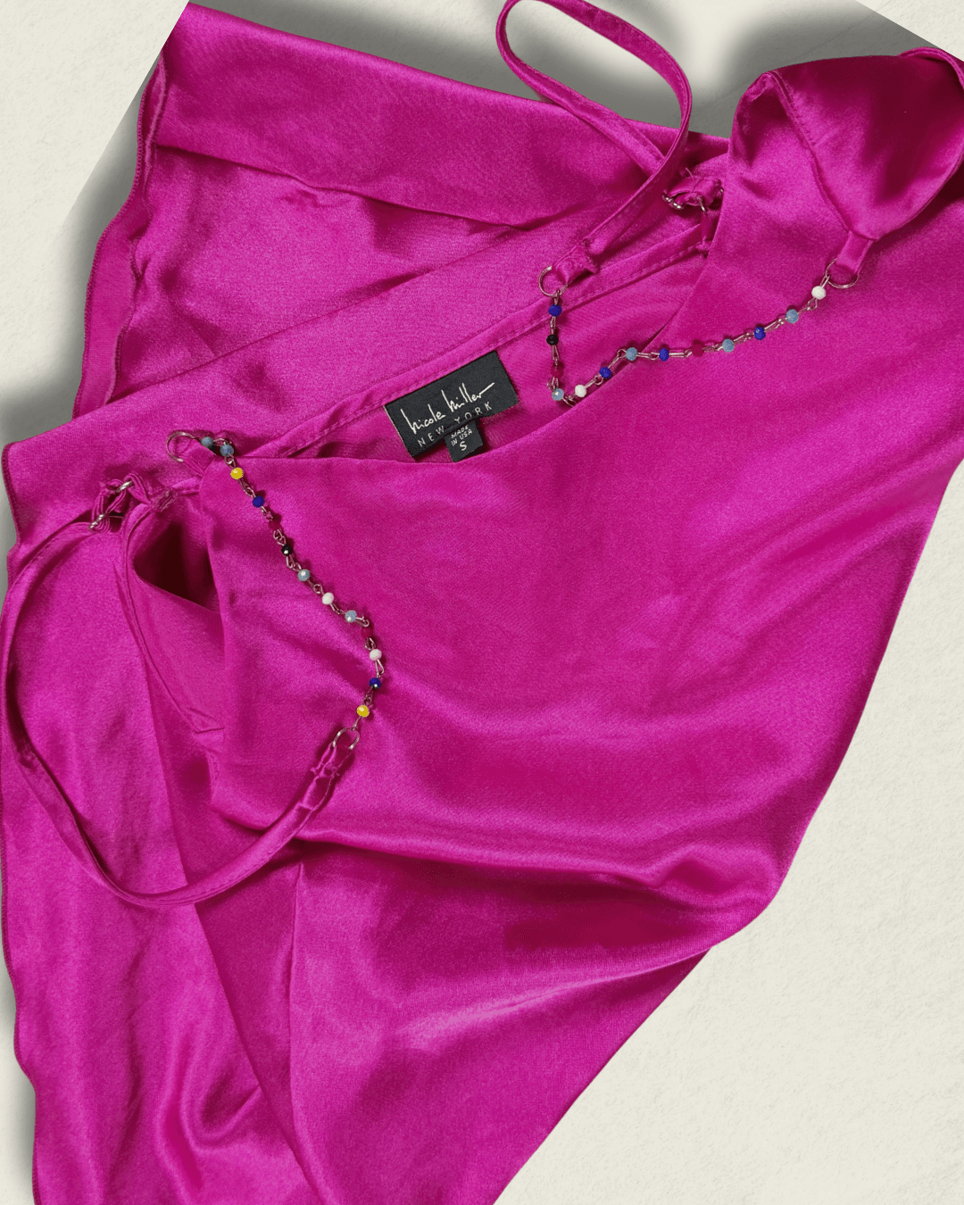 Y2K fuchsia Nicole Miller bias-cut silk camisole with multicolor hand-beaded straps and a draped neckline, shown flat.