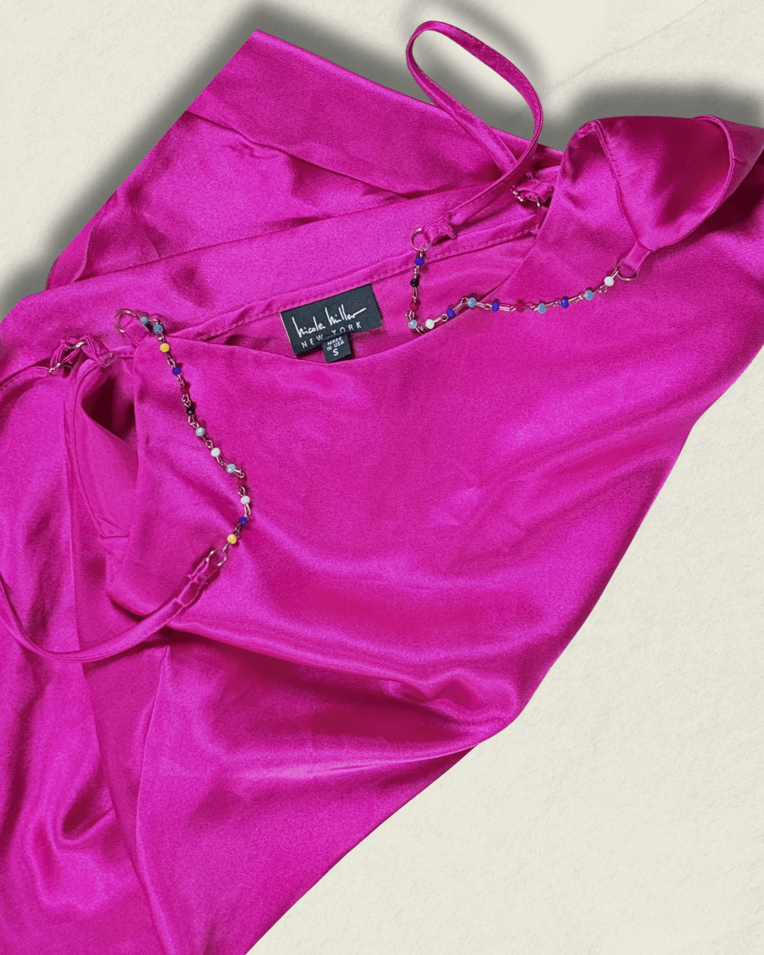 Y2K fuchsia Nicole Miller bias-cut silk camisole with multicolor hand-beaded straps and a draped neckline, shown flat.