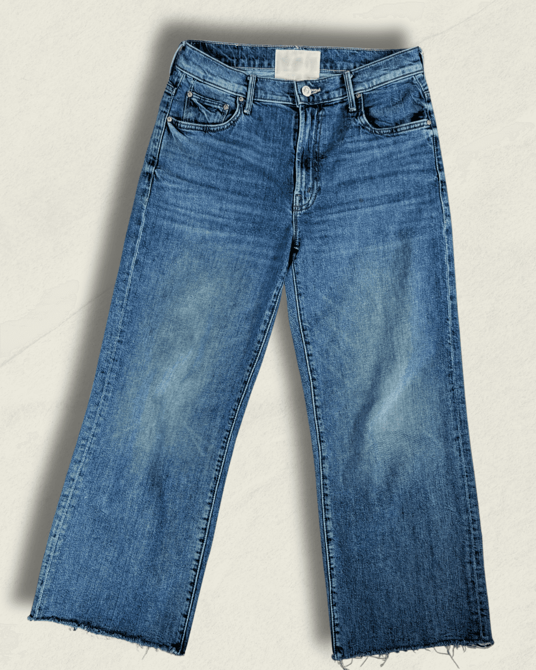 MOTHER Mid-Rise Maven Ankle wide-leg jean in medium blue denim with a raw frayed hem and crown-stitch back pockets, shown flat.