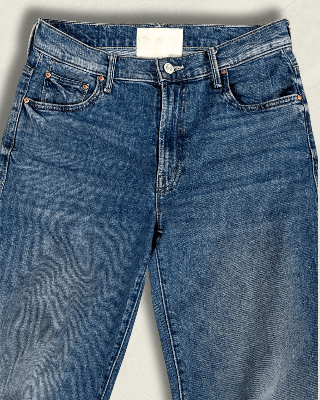 MOTHER Mid-Rise Maven Ankle wide-leg jean in medium blue denim with a raw frayed hem and crown-stitch back pockets, shown flat.