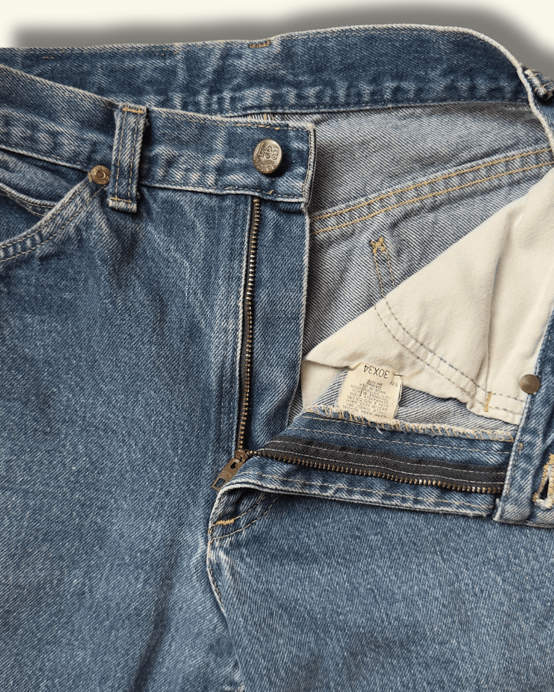 Paint-marked vintage Lee Riders medium-wash straight-leg jeans, model 200-0147, tagged 30 x 34