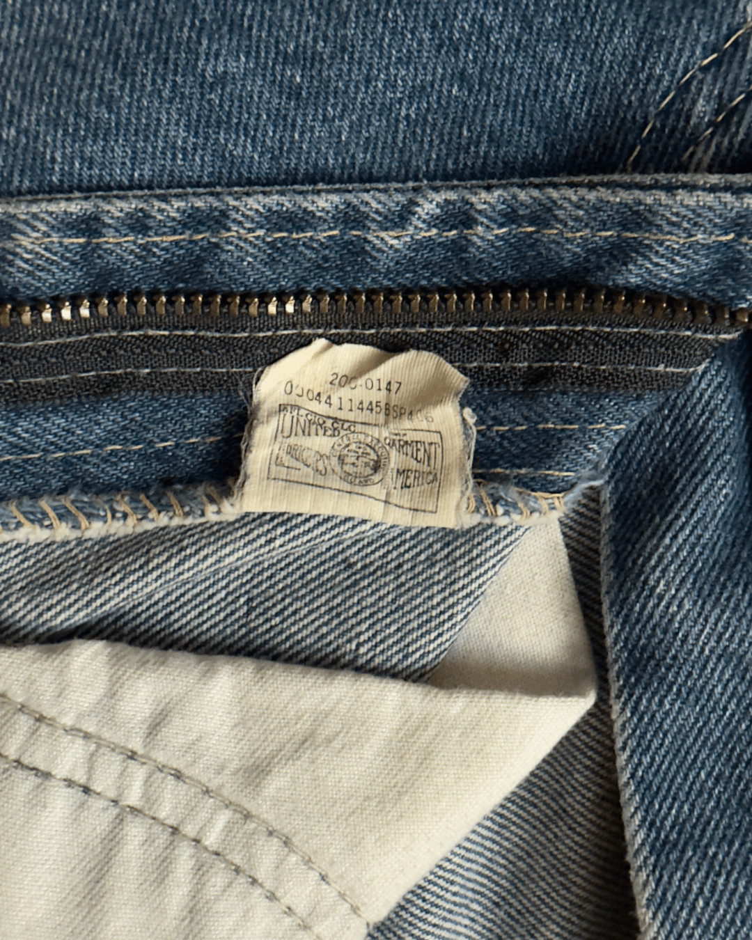 Paint-marked vintage Lee Riders medium-wash straight-leg jeans, model 200-0147, tagged 30 x 34