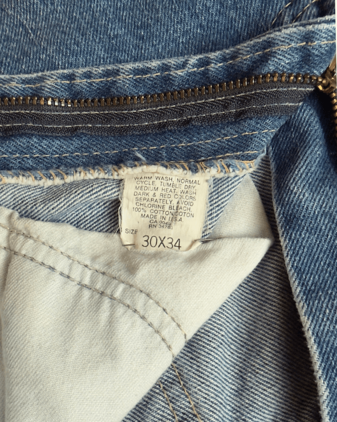 Paint-marked vintage Lee Riders medium-wash straight-leg jeans, model 200-0147, tagged 30 x 34