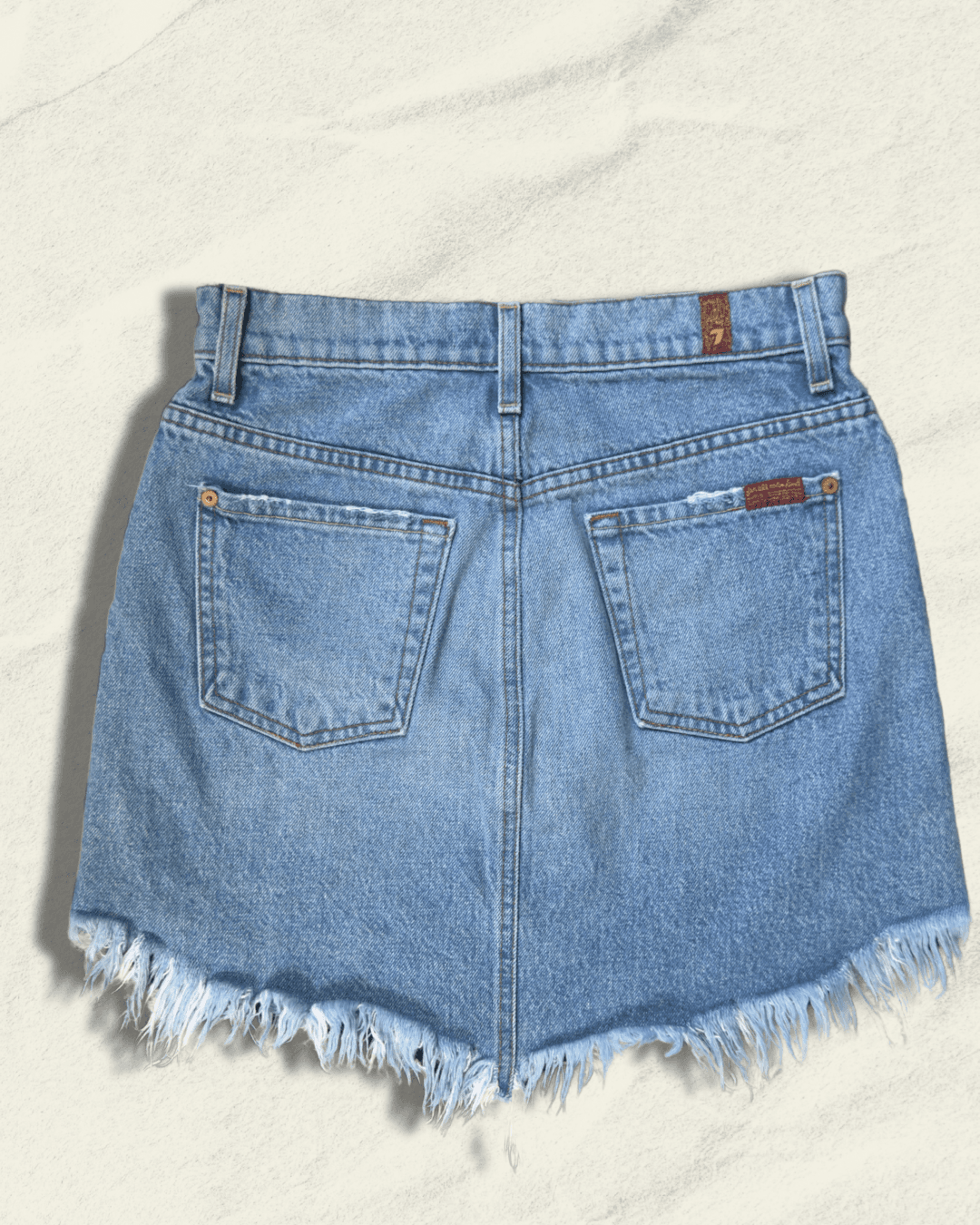 7 For All Mankind light-wash distressed denim mini skirt with raw fringed asymmetric hem, size 25