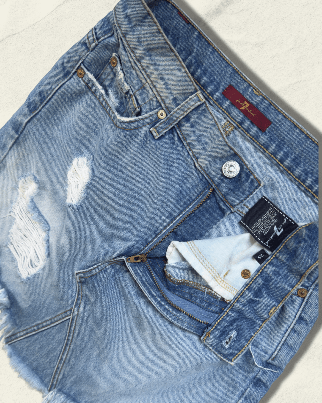 7 For All Mankind light-wash distressed denim mini skirt with raw fringed asymmetric hem, size 25