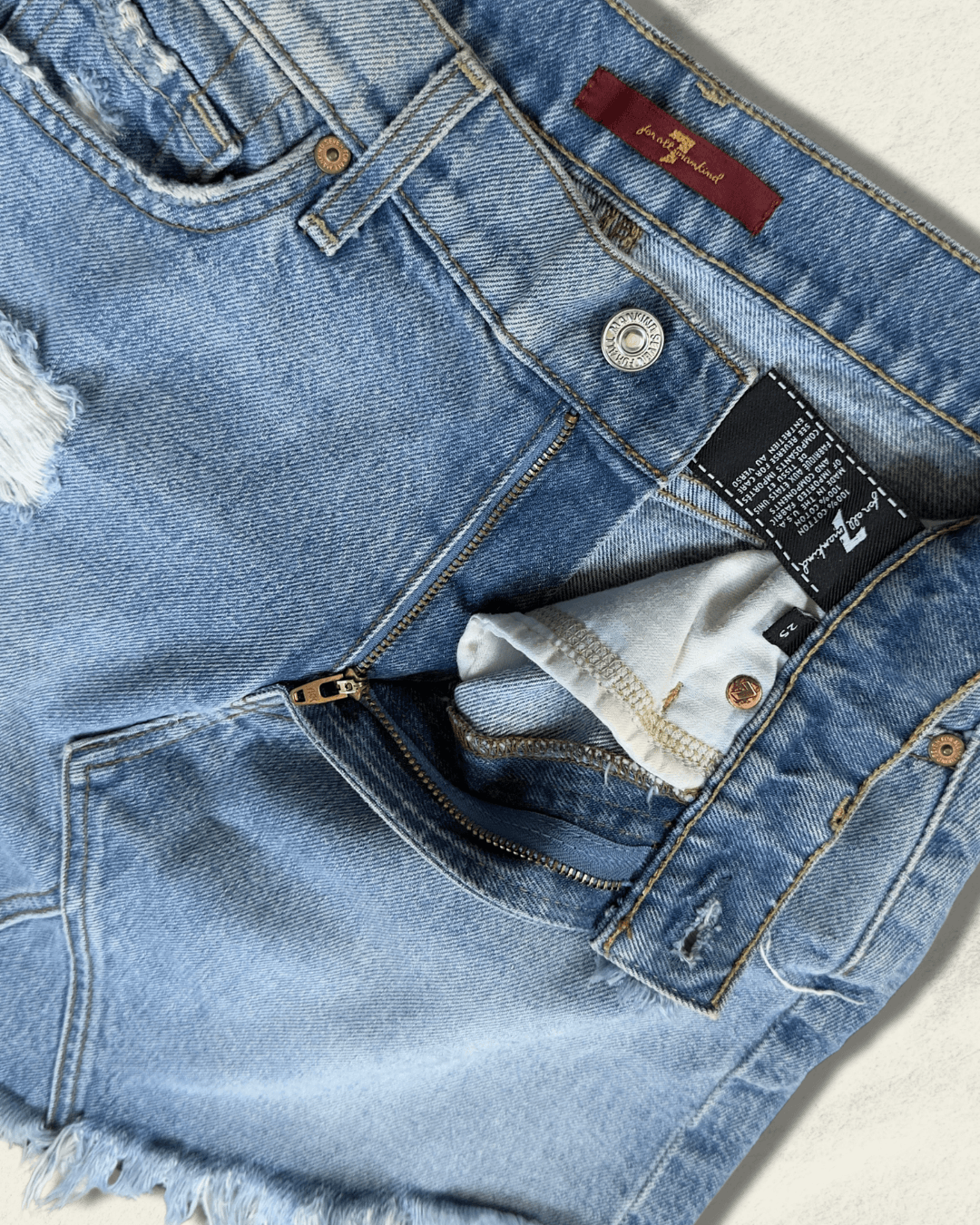 7 For All Mankind light-wash distressed denim mini skirt with raw fringed asymmetric hem, size 25
