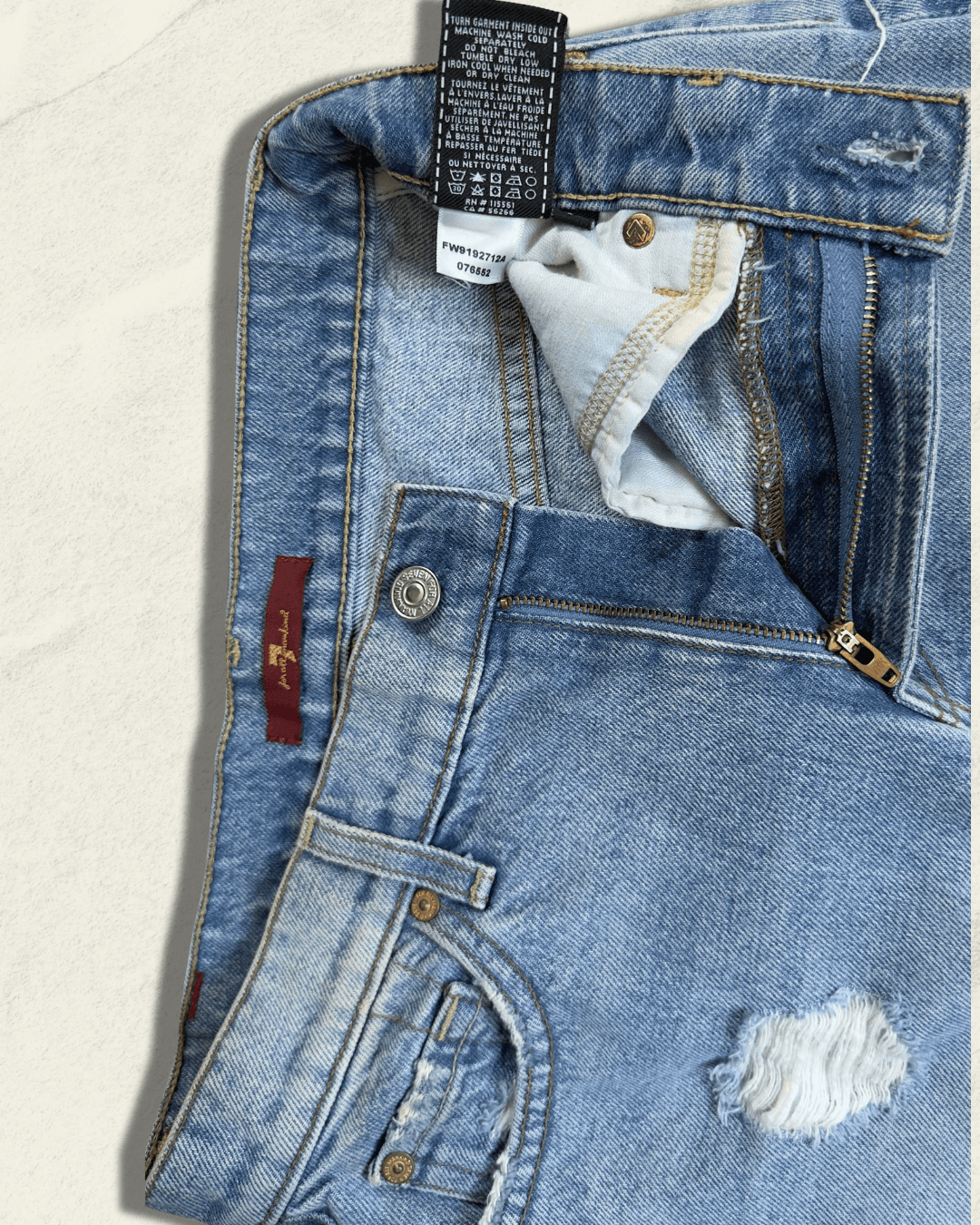 7 For All Mankind light-wash distressed denim mini skirt with raw fringed asymmetric hem, size 25