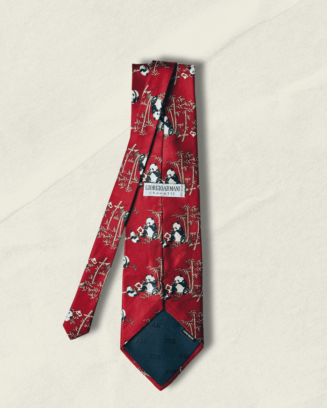 Vintage Giorgio Armani Cravatte tie in lacquer red, printed with pandas in a bamboo grove, styled over a white shirt and houndstooth jacket.